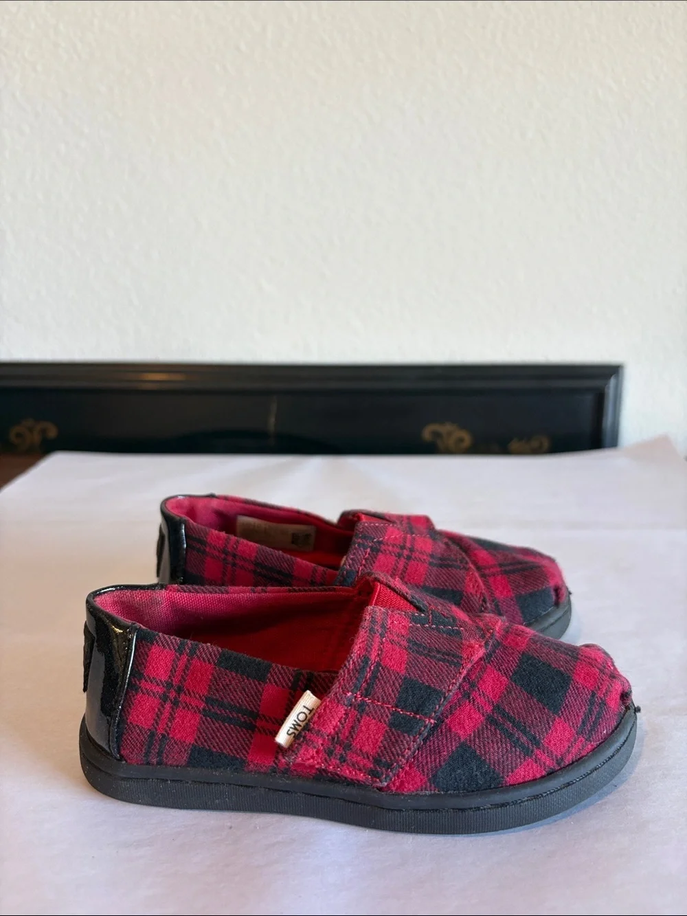 TOMS Black and Red Plaid Slip on shoes